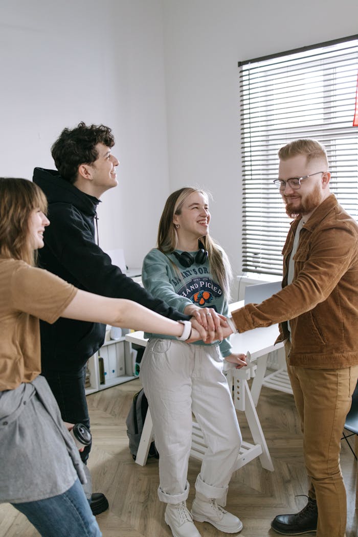 Group of young adults working as a team in a modern office setting.